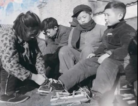 上世紀(jì)50年代，孩子們?cè)诖┠景灞?圖源：北京日?qǐng)?bào))