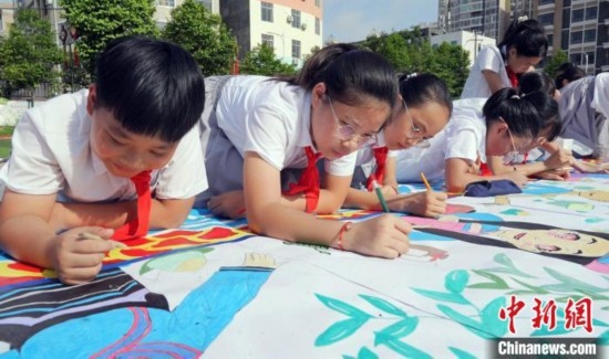 圖為學生們用手中畫筆在進行創(chuàng)作。 興業(yè)縣融媒體中心供圖