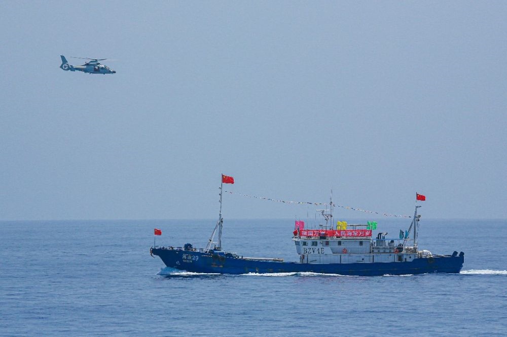 ↑中國(guó)海軍第40批護(hù)航編隊(duì)中的艦載直升機(jī)在被護(hù)船只周邊海域巡邏警戒（2022年6月4日攝）。新華社發(fā)（唐文 攝）