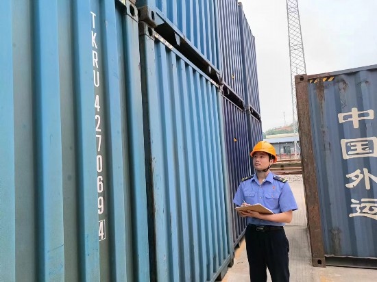 鐵路貨運員在檢查集裝箱箱體情況、記錄箱號。中國鐵路廣州局集團有限公司供圖