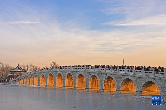 這是12月22日拍攝的頤和園十七孔橋“金光穿洞”景象。