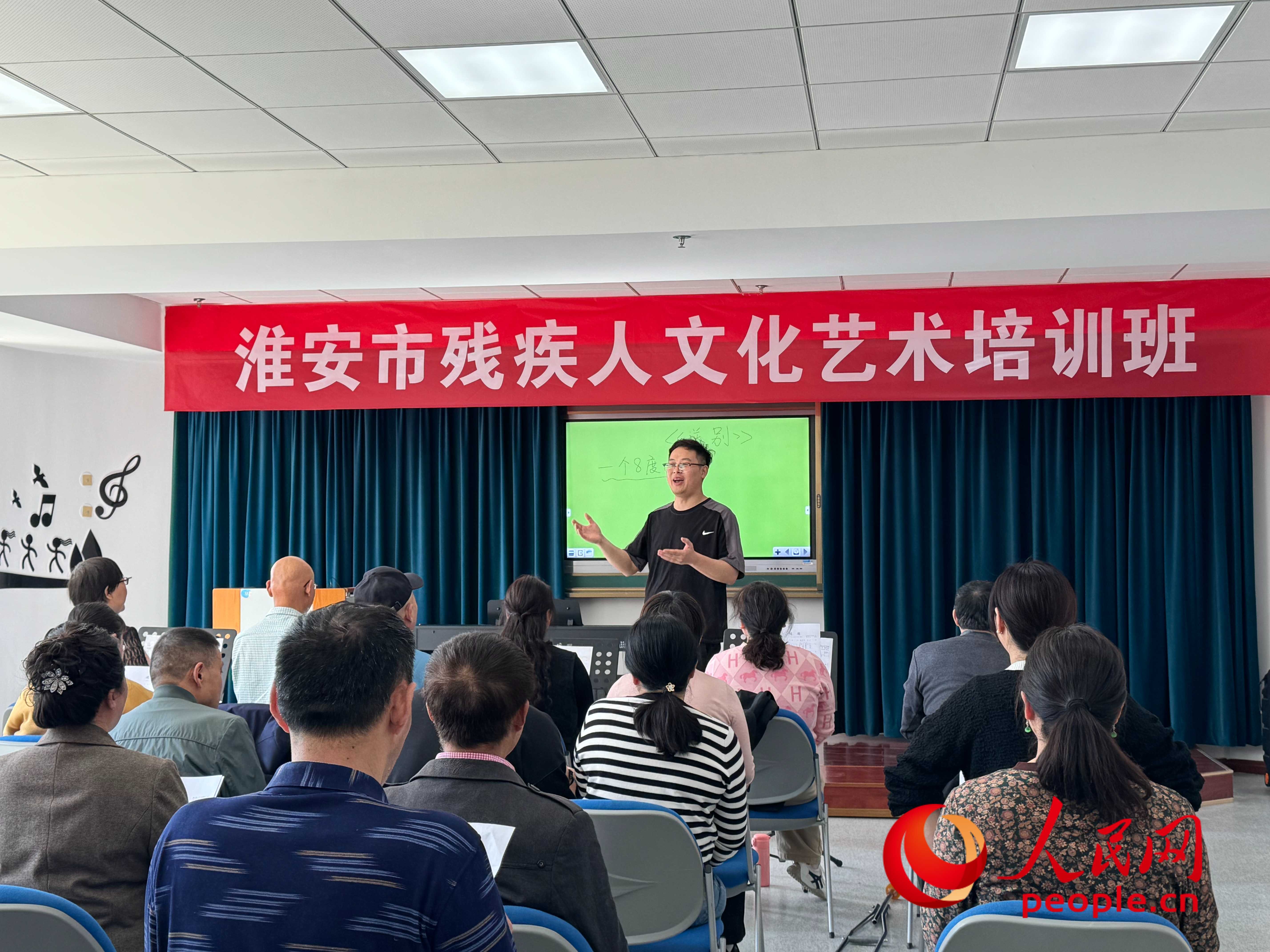 在淮安市殘疾人文化藝術(shù)培訓(xùn)班上，聲樂老師在教殘疾人唱《送別》這首歌曲。人民網(wǎng) 周靜圓攝