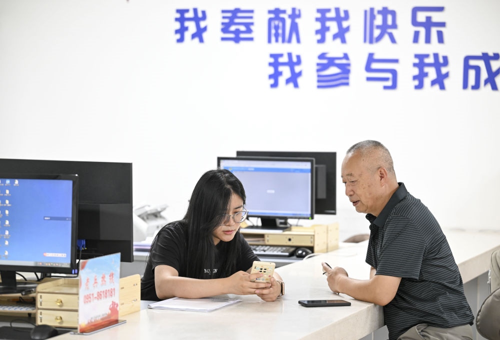 6月20日，在長(zhǎng)城花園社區(qū)黨群服務(wù)中心，工作人員幫助居民辦理業(yè)務(wù)。