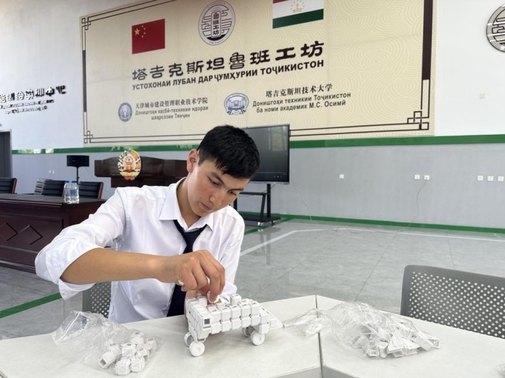 在塔吉克斯坦魯班工坊內(nèi)，學(xué)員正在操作能力源創(chuàng)新套件。本報(bào)記者 屈佩 攝