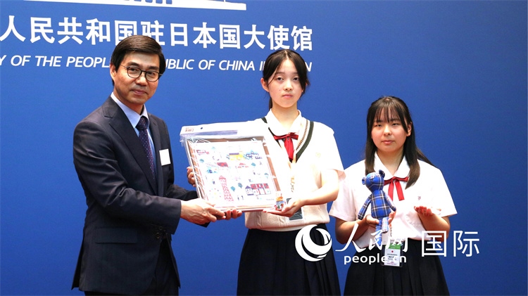 日本小大使向中國駐日本大使館臨時代辦施泳贈送當?shù)靥厣Y品。人民網(wǎng) 許可攝