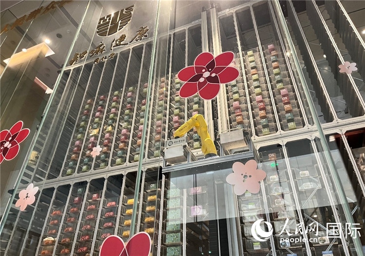 6. 機(jī)械臂正在取貨。（人民網(wǎng)記者陳思 攝）